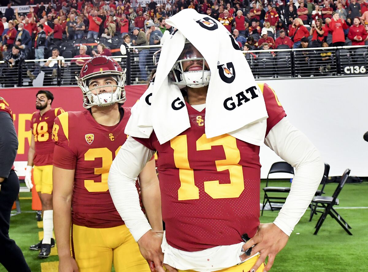 USC quarterback Caleb Williams covers his helmet with a towel during the final moments of a 47-24 loss.