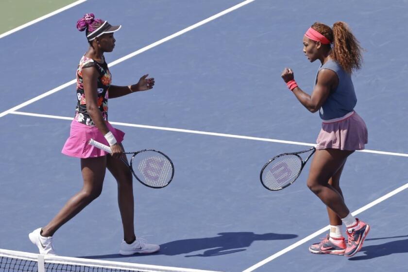 Venus, left, and Serena Williams advanced to the semifinals in women's doubles at the U.S Open.
