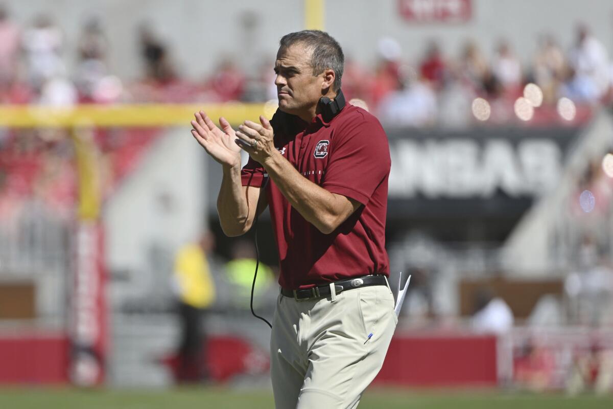 South Carolina coach Shane Beamer goes out to talk to his team during a time out against Arkansas during the first half of an NCAA college football game Saturday, Sept. 10, 2022, in Fayetteville, Ark. (AP Photo/Michael Woods)