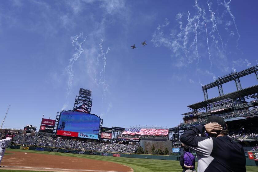 Two F-16 jets from Buckley Air Force Base in Aurora, Colo., fly over Coors Field before a baseball game between the Los Angeles Dodgers and the Colorado Rockies on opening day, Thursday, April 1, 2021, in Denver. The Rockies won 8-5. (AP Photo/David Zalubowski)