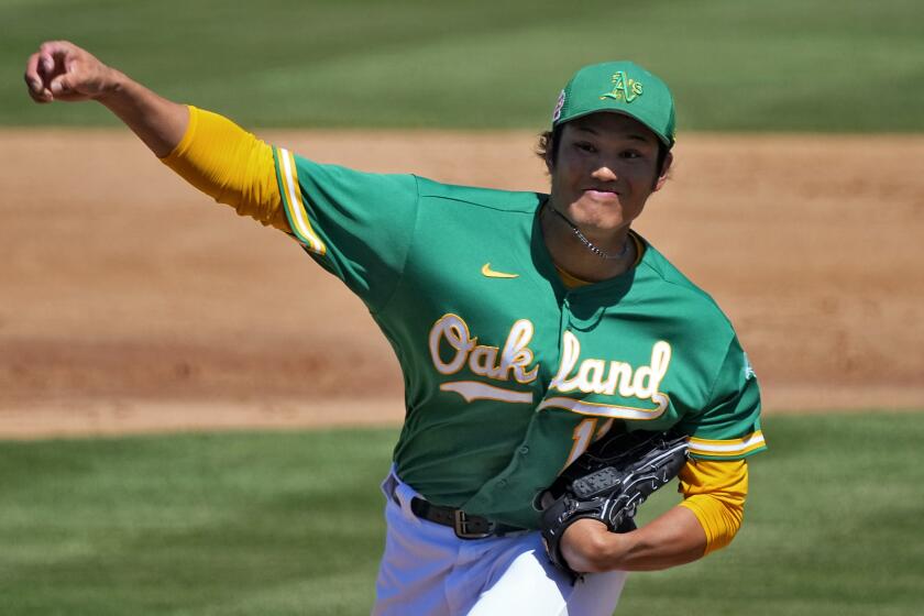 Oakland Athletics starting pitcher Shintaro Fujinami (11), of Japan, throws against the Milwaukee Brewers.