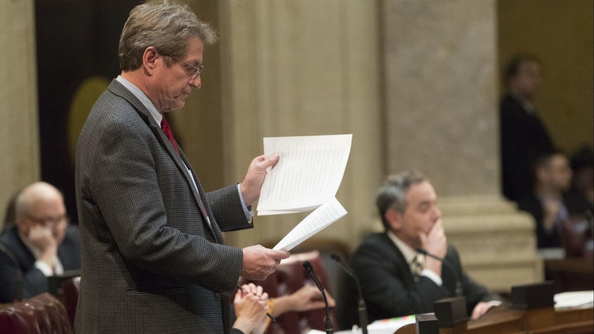 Wisconsin Sen. Tim Carpenter, a Democrat, questions a list of appointment referrals submitted to the Senate at the Capitol in Madison on Tuesday.