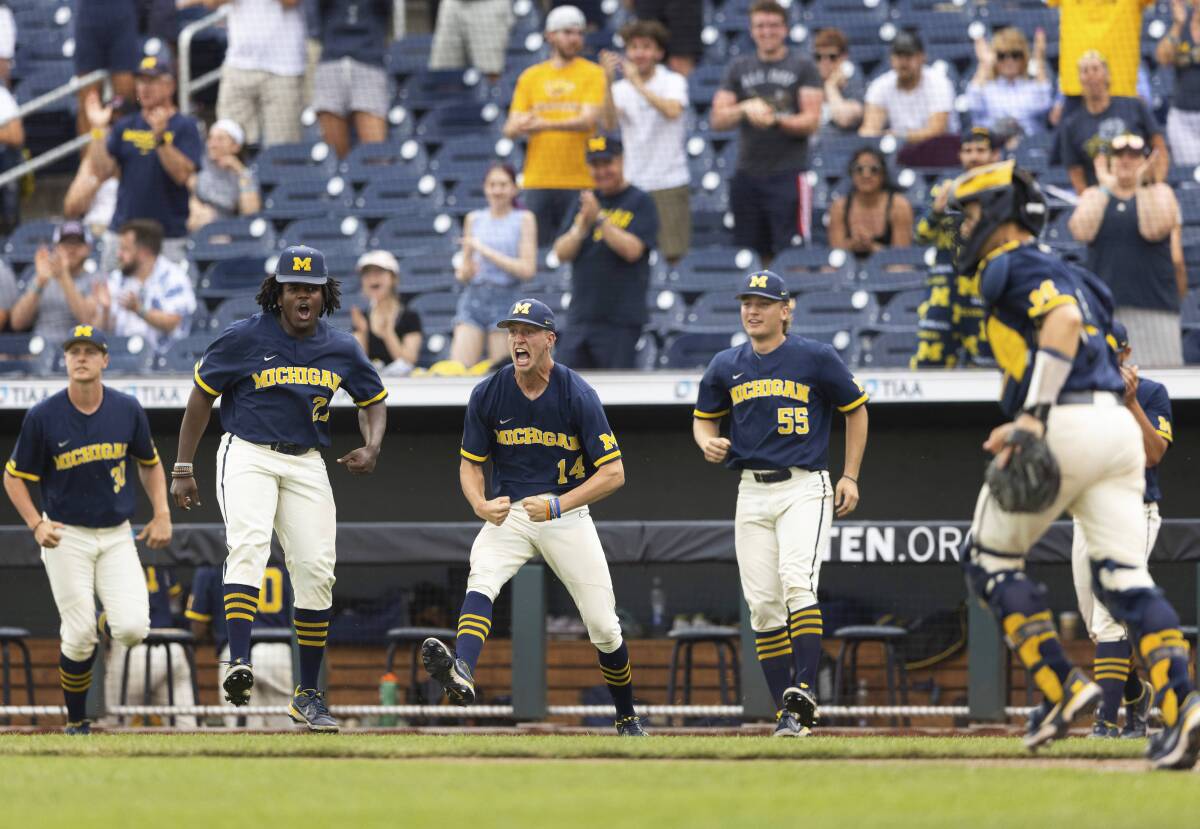 From left to right, Michigan players Jaylen Jones, Avery Goldensoph and Cameron Weston celebrate after pitcher Jacob Denner (not shown) struck out Rutgers with the bases loaded to close the sixth inning of the NCAA college Big Ten baseball championship game Sunday, May 29, 2022, at Charles Schwalb Field in Omaha, Neb. (AP Photo/Rebecca S. Gratz)