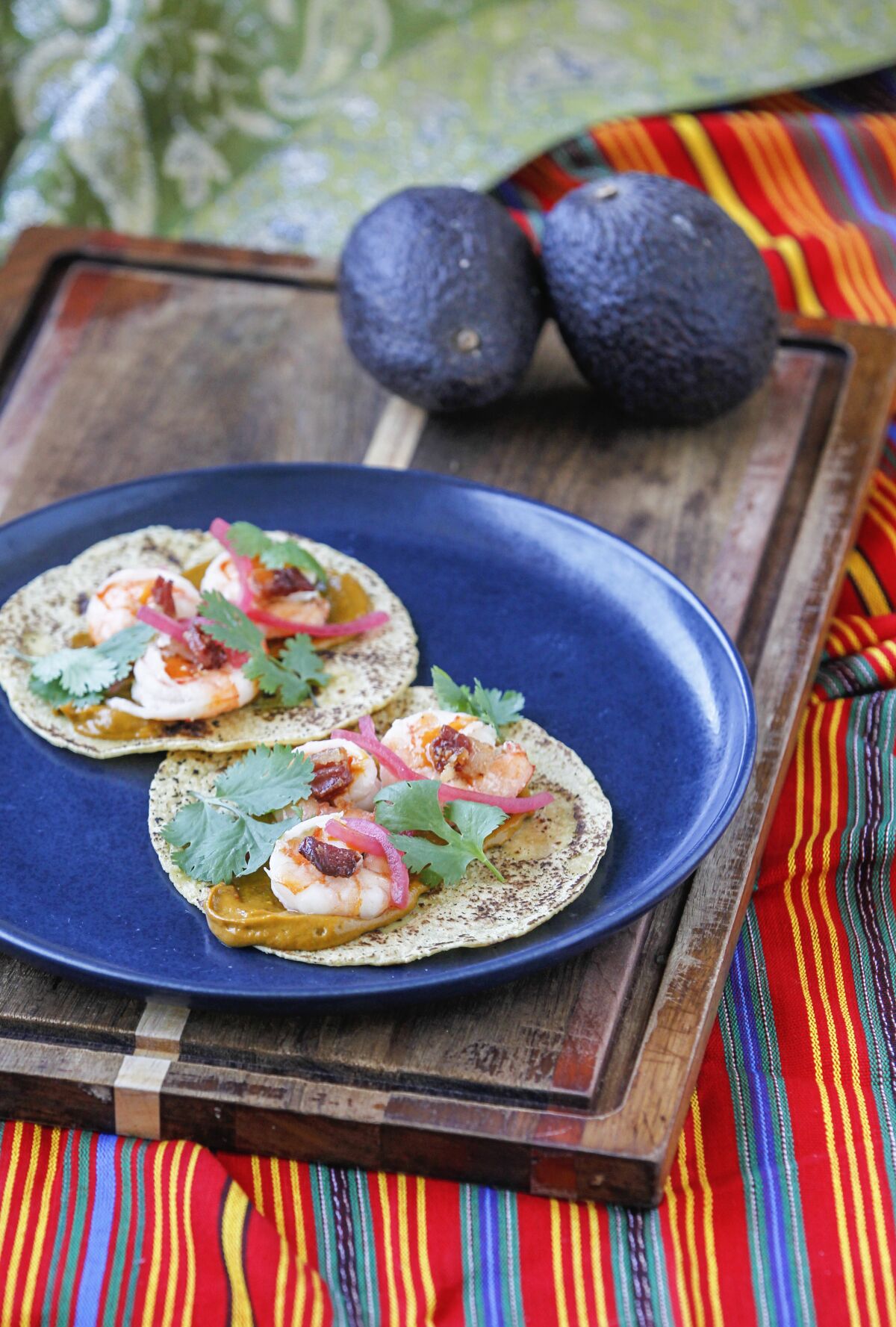 Bacon Poached Shrimp Tacos With Chipotle-Avocado Sauce and Pink Pickled Onion.