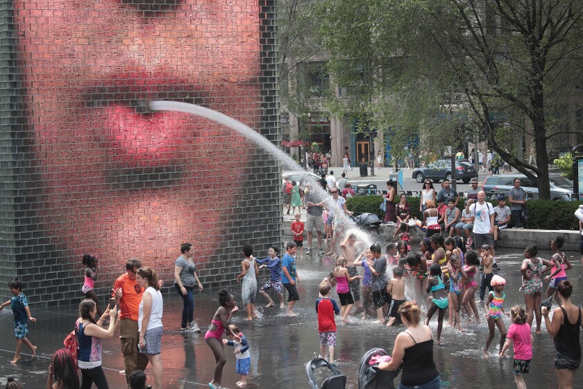 People cool off downtown in Crown Fountain as temperatures climb into the 90s on Saturday in Chicago. The heat wave gripping the city is affecting nearly two-thirds of the United States where more than 195 million people will experience temperatures above 90 degrees over the next few days.