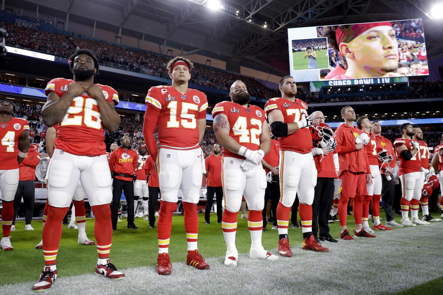Kansas City Chiefs quarterback Patrick Mahomes (15) and teammates stand during the national anthem before Super Bowl LIV.