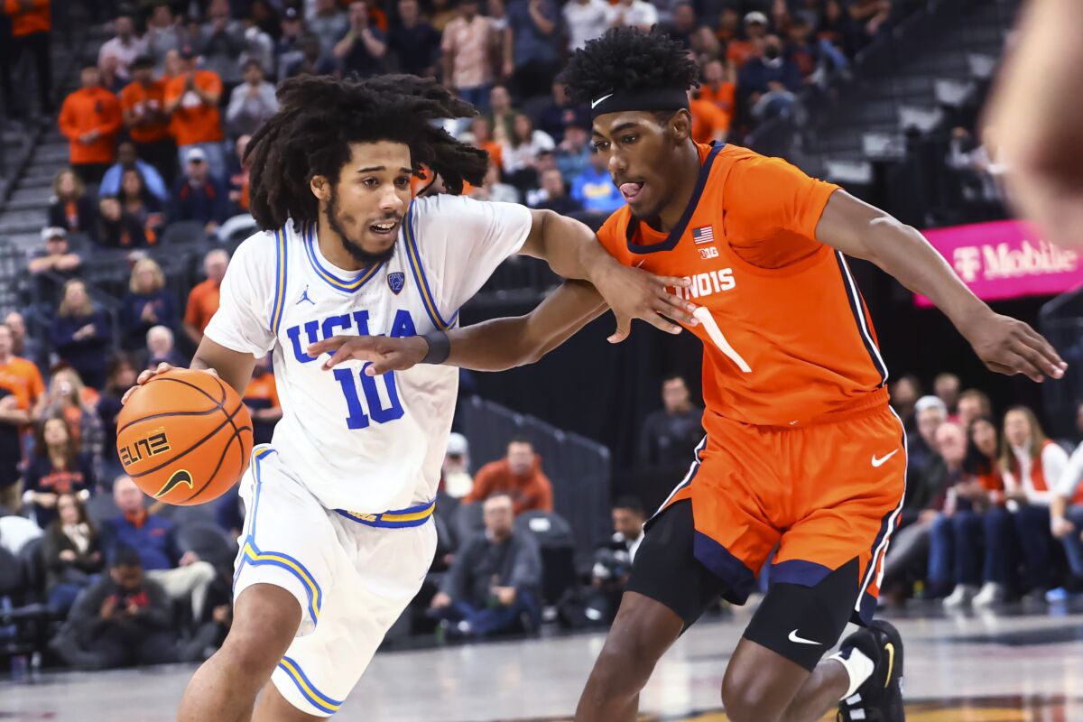 UCLA guard Tyger Campbell, left, drives against Illinois guard Sencire Harris during the second half Friday.