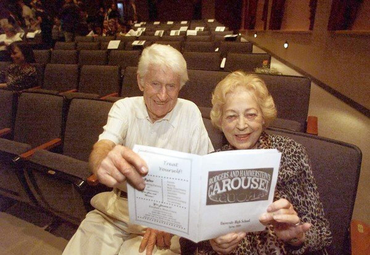 John and Lee Childress review a program from one of the many high school theater productions they attended.