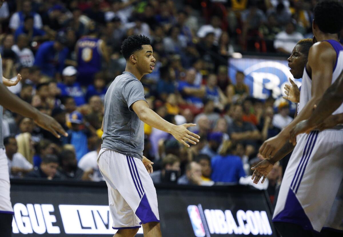 Lakers rookie D'Angelo Russell bonds with some teammates during a NBA summer league game against the Minnesota Timberwolves on July 10.