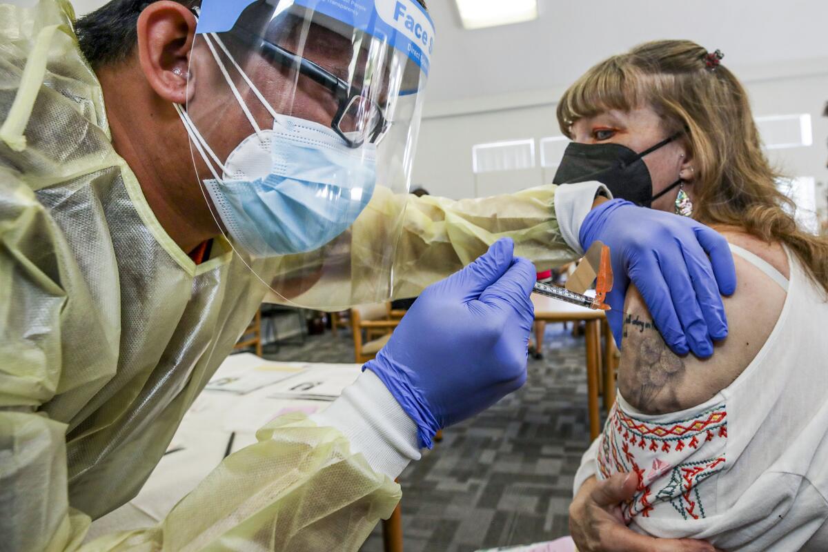 A woman gets a COVID-19 vaccination shot