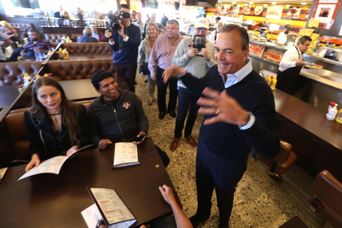 Mayoral candidate Rick Caruso speaks to customers before having lunch at Langer's Deli.