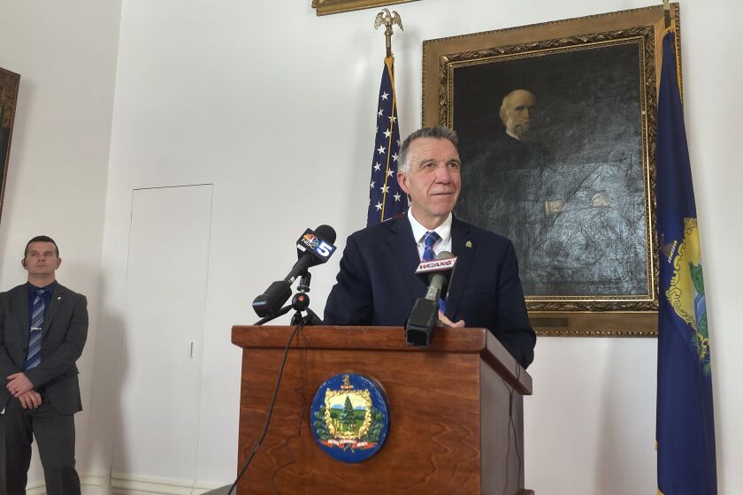 Vermont Republican Gov. Phil Scott, right, faces reporters at the Statehouse, in Montpelier, Vt., Tuesday Feb. 7, 2023, as he calls for a return to civility. Speaking in the aftermath of a Jan. 31 brawl at a middle school basketball game that ended with the death of one of the participants, Scott said there is too much anger in contemporary society. He said "all of us have an obligation to tone down the rhetoric and recognize the humanity in everyone." (AP Photo/Wilson Ring)