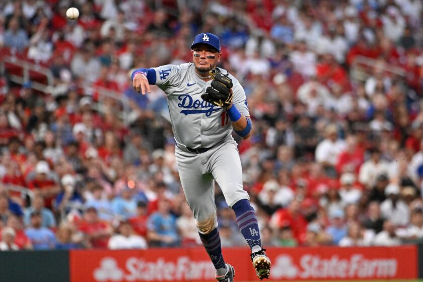 ST LOUIS, MISSOURI - AUGUST 16: Miguel Rojas #11 of the Los Angeles Dodgers throws to first base.