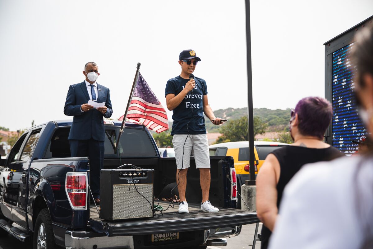 Caleb Dominguez, who organized the flag parade, speaks to participants before heading out in Chula Vista.