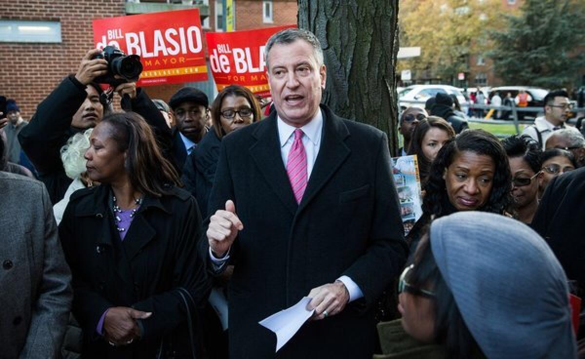 New York City Mayoral candidate Bill De Blasio speaks to campaign supporters in a public housing village in the Queens borough of New York City.