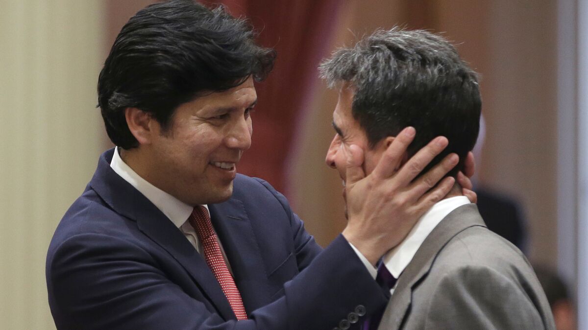 Senate leader Kevin de León (D-Los Angeles), left, congratulates Sen. Mark Leno (D-San Francisco), chairman of the Senate budget committee after lawmakers approved the 2016-2017 state budget.