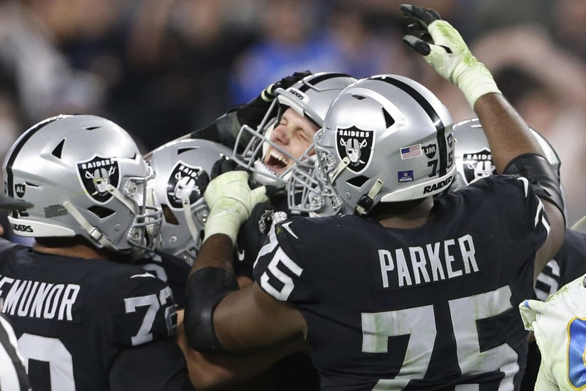 Las Vegas Raiders kicker Daniel Carlson, center, celebrates after kicking the game-winning field goal against the Chargers.