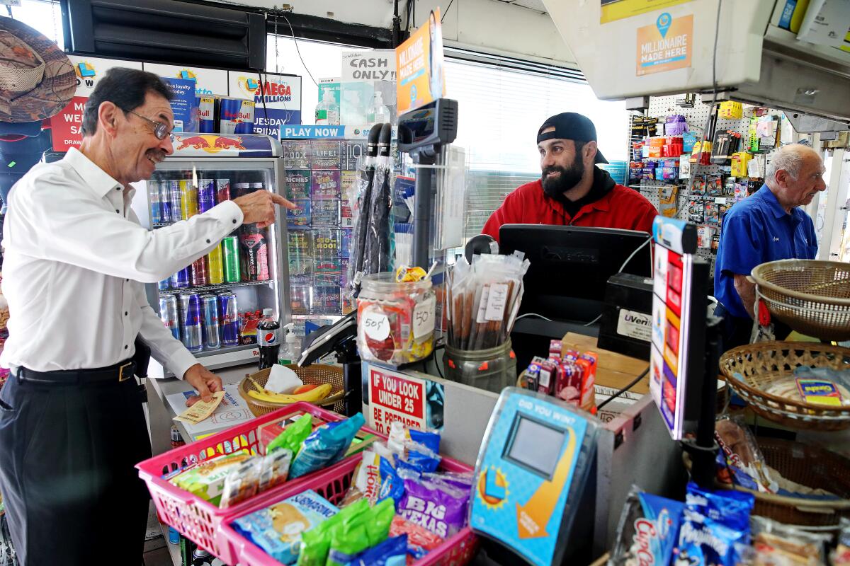 A customer at a gas station speaks to the clerk
