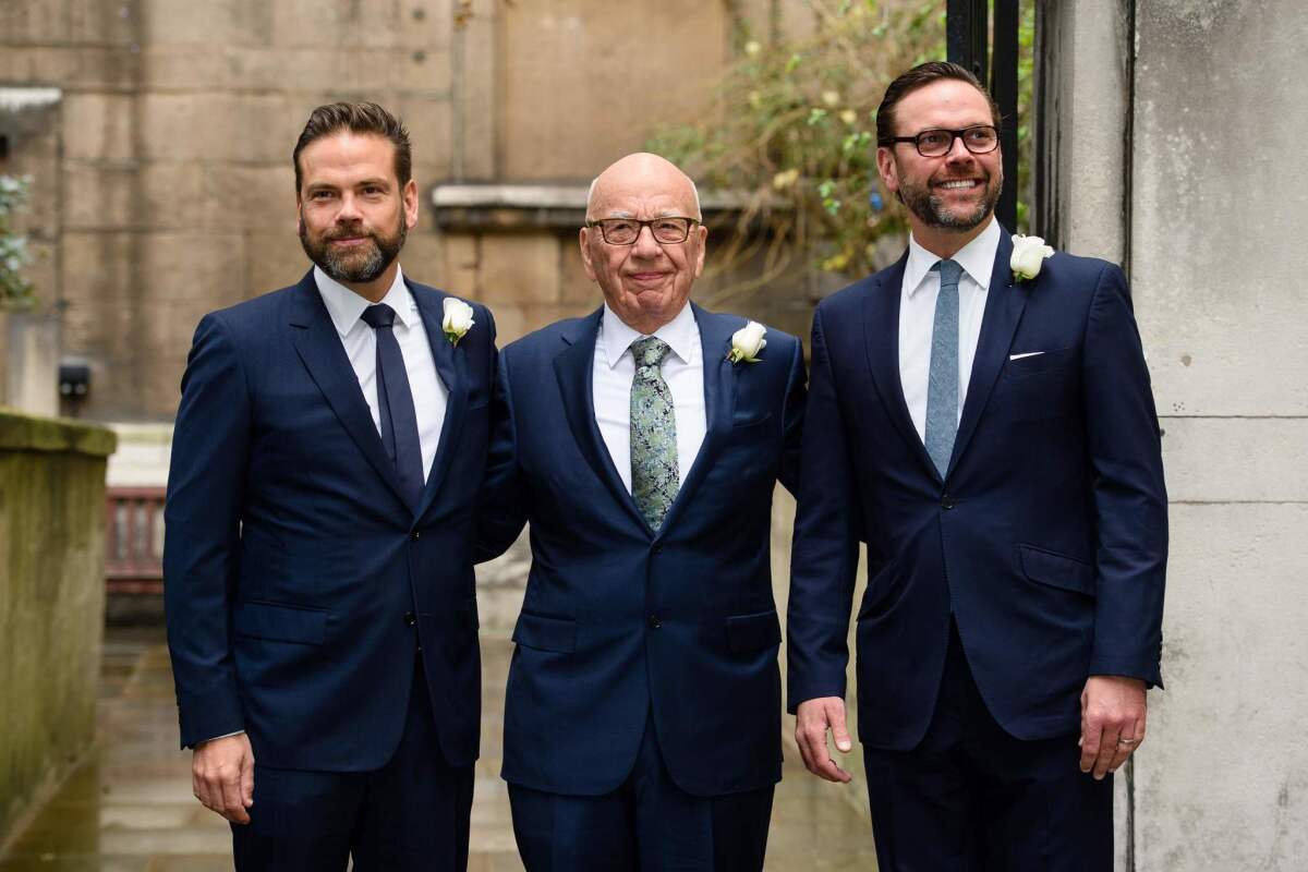 Rupert Murdoch, center, is shown with his sons, Lachlan, at left, and James in March.