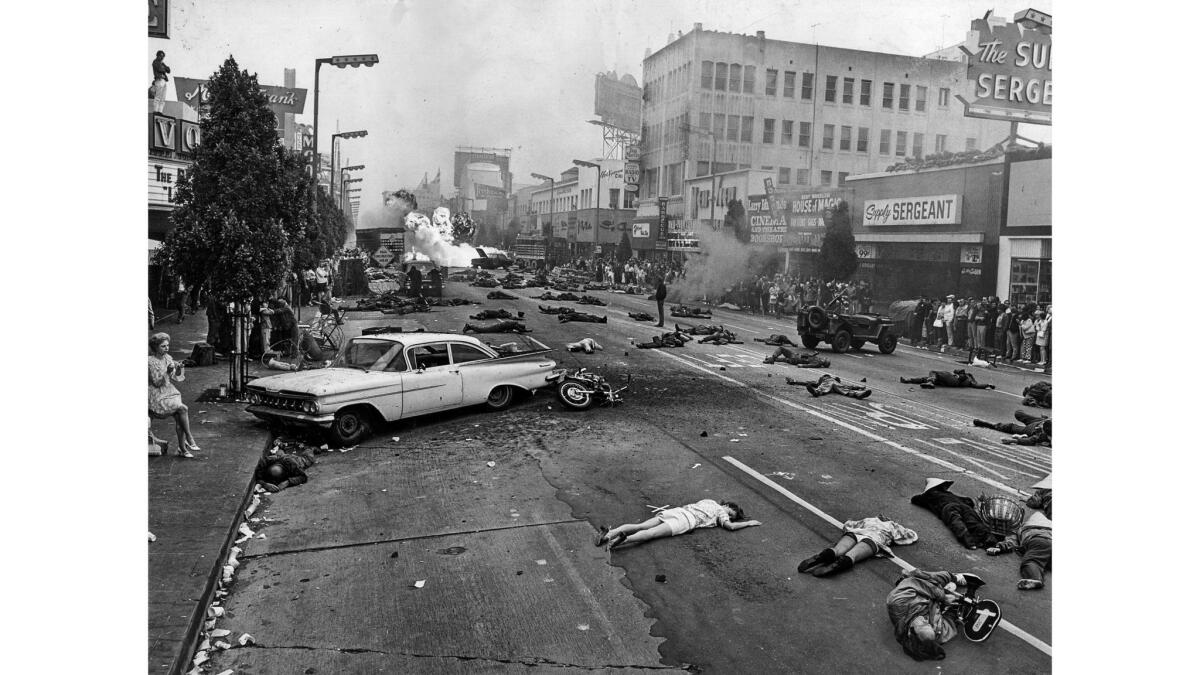 May 24, 1970: ... and action! Actors play victims of a bombing on Hollywood Boulevard as startled residents watch from the side.