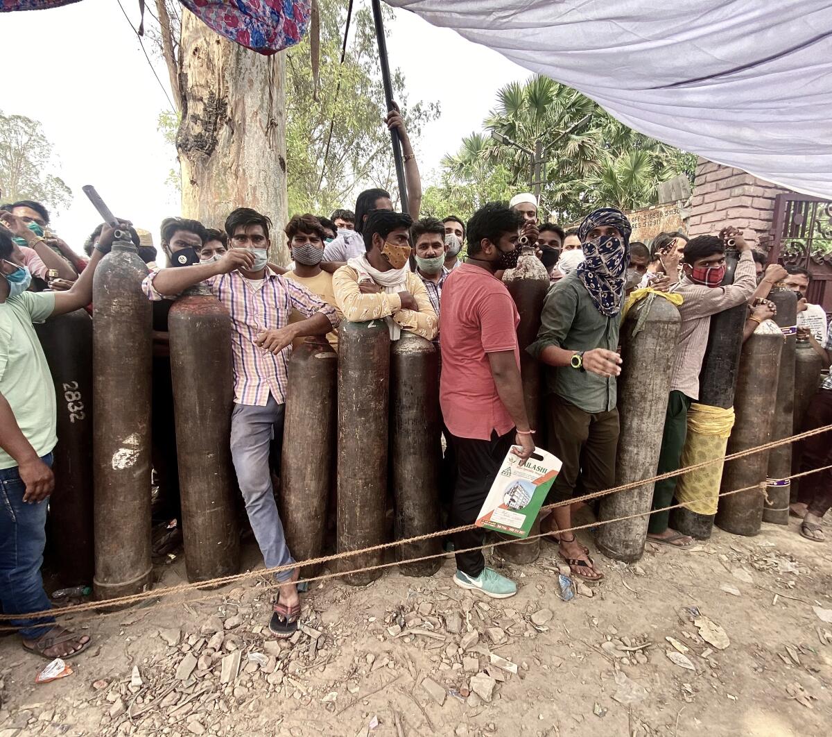 Men line up at an oxygen refilling center in Meerut, India.