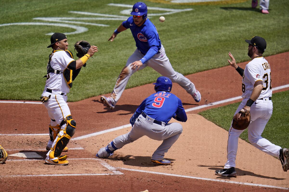 Javier Baez (9) escaped this rundown between home and first in a bizarre play against the Pirates on May 27.