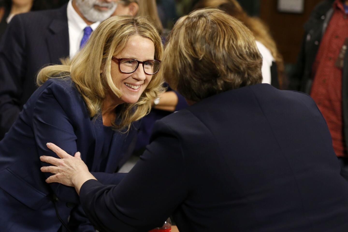 Dr. Christine Blasey Ford shakes hands with attorney Debra Katz after the Senate Judiciary Committee hearing on the nomination of Brett Kavanaugh to be an associate justice of the Supreme Court of the United States, on Capitol Hill.