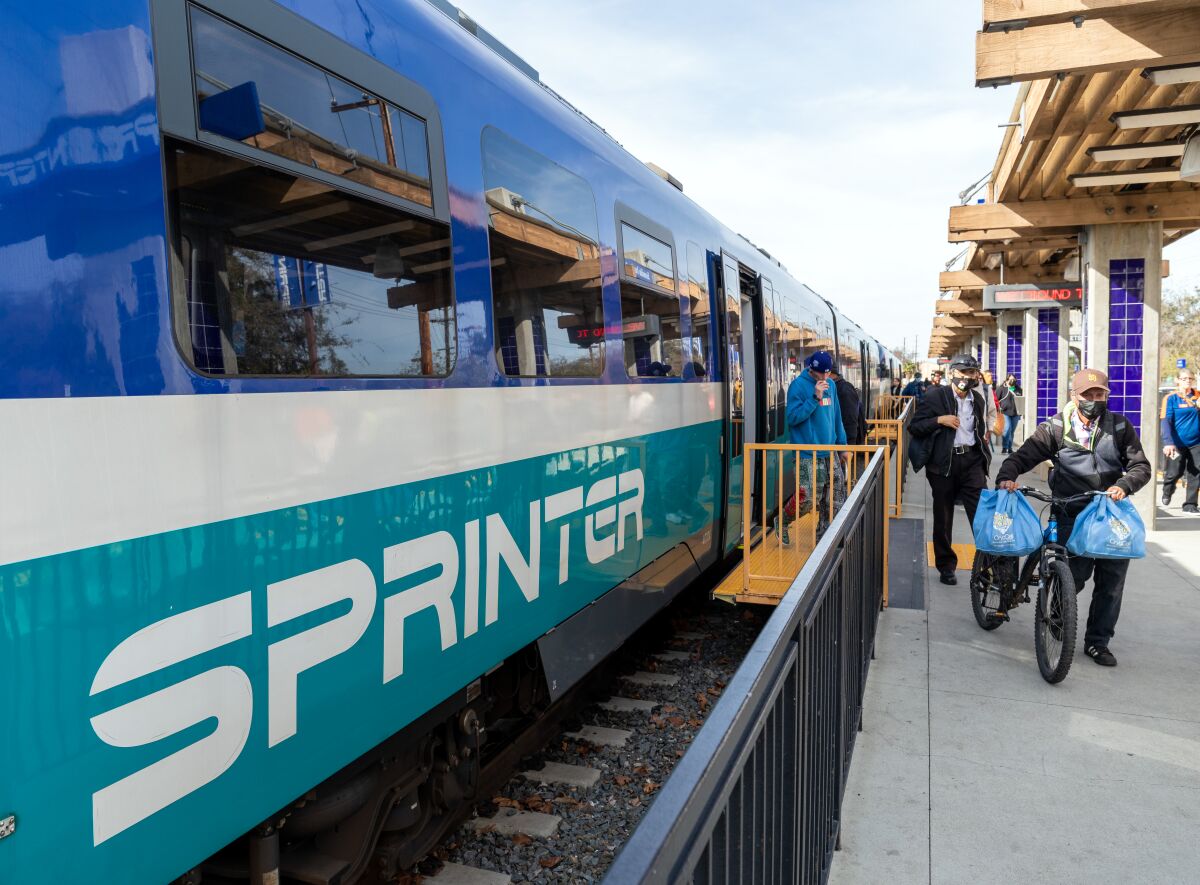 Passengers disembark from the Sprinter train at the Escondido transit center on Thursday. 
