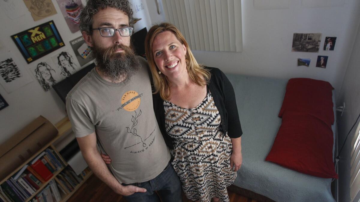 Blair Overstreet and her husband Matt Dunn stand in their spare bedroom that they hope to be able to offer to a family that is part of the Central American caravan seeking asylum in the U.S.