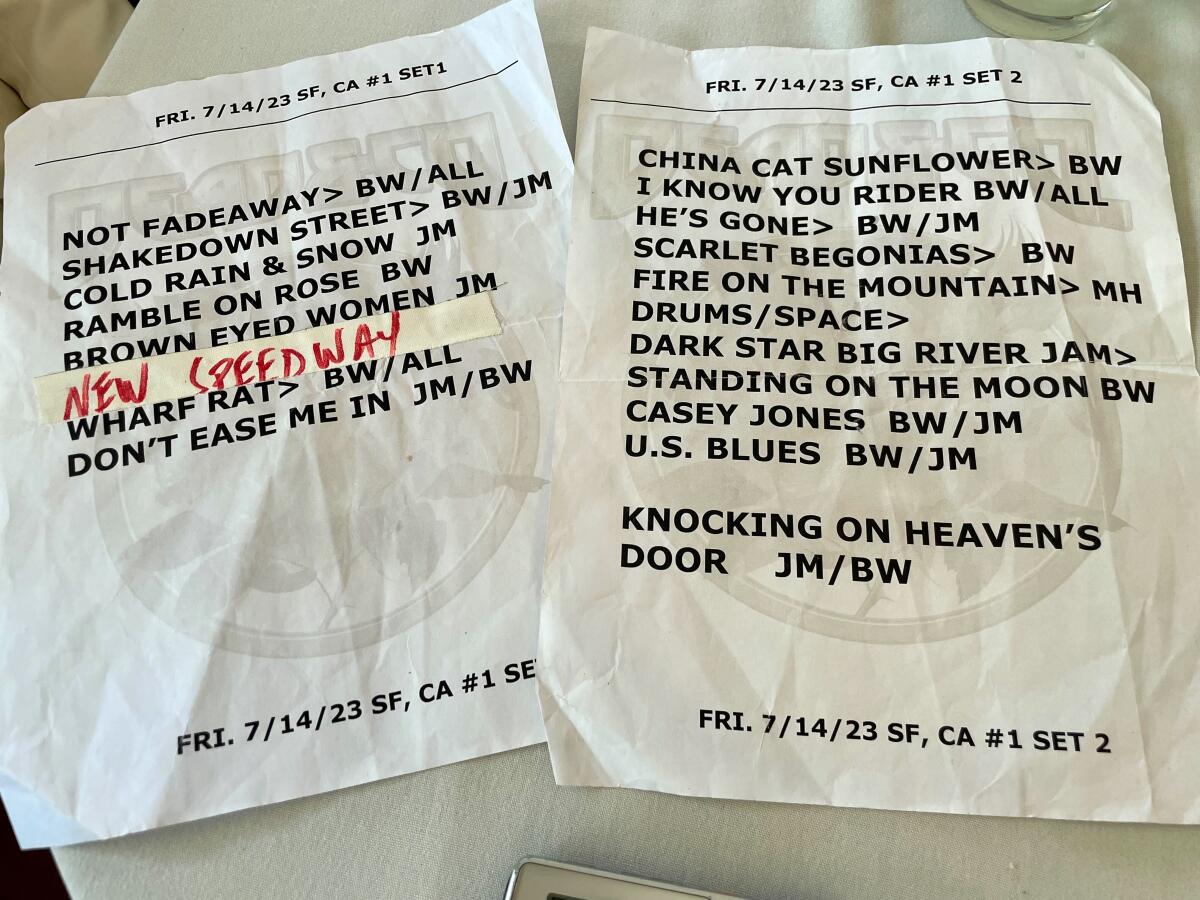 Two sheets of paper with song titles on them