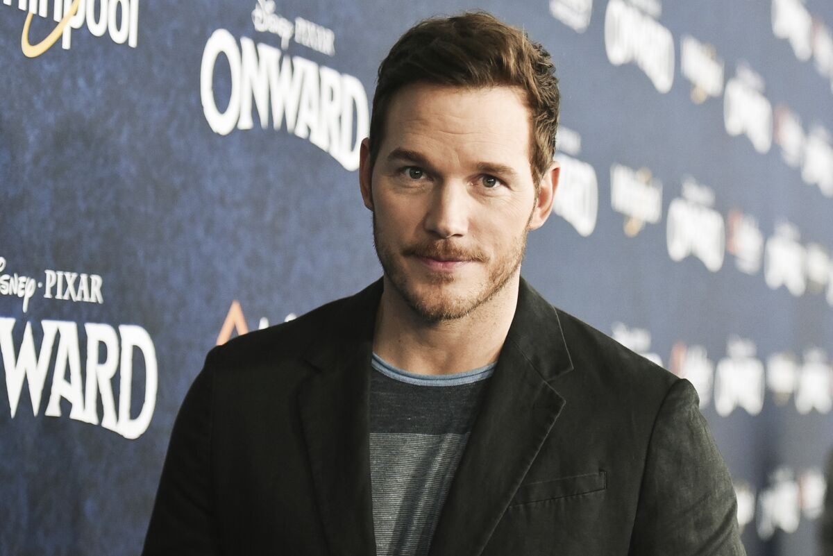 A closeup of Chris Pratt in a black sport coat and T-shirt.
