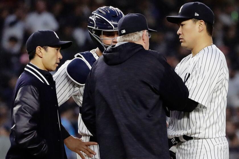 New York Yankees starting pitcher Masahiro Tanaka, of Japan, right, talks to catcher Gary Sanchez, second from left, pitching coach Larry Rothschild and translator Shingo Horie, left, during the fourth inning of a baseball game Tuesday, June 6, 2017, in New York. (AP Photo/Frank Franklin II)