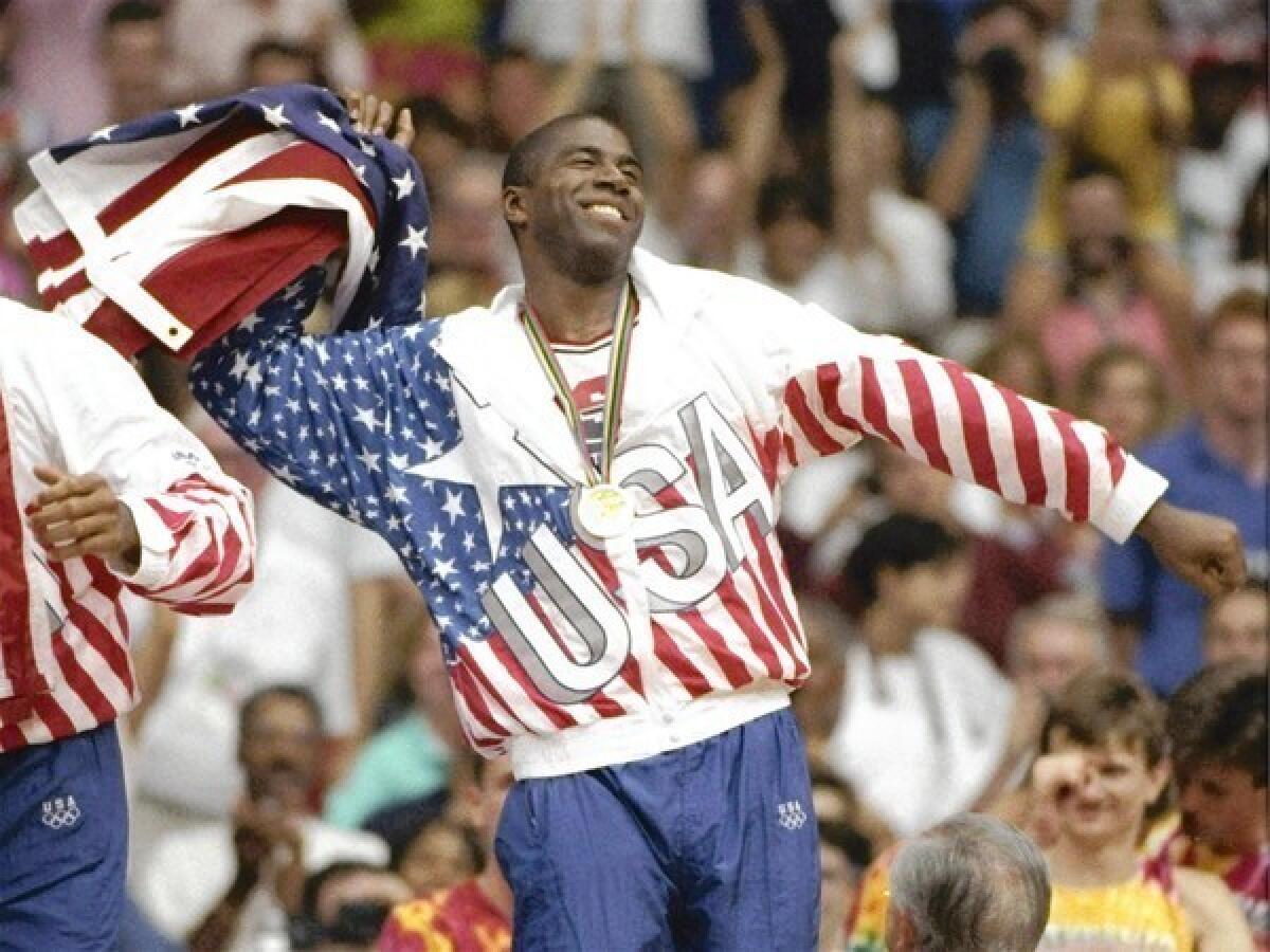 Earvin "Magic" Johnson whips the United States flag in ecstasy during the gold medal ceremony on Aug. 8, 1992, during the 1992 Summer Olympic games in Barcelona.