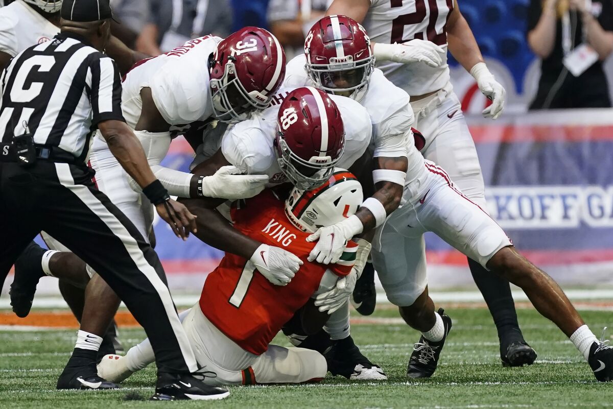 Miami quarterback D'Eriq King (1) is sacked by Alabama's Phidarian Mathis (48), Will Anderson Jr. (31) and Malachi Moore (13) during the second half of an NCAA college football game Saturday, Sept. 4, 2021, in Atlanta. (AP Photo/John Bazemore)