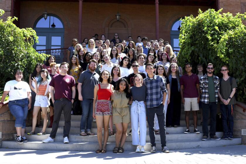 In this 2019 photo provided by The State Press is Andrew Howard, second row center left, a managing editor of The State Press, standing with the staff of the student newspaper in Phoenix. Howard, 20, a student at Arizona State University broke the news that a key State Department official who was involved in talks between President Donald Trump and the Ukrainian government had stepped down from his post. Howard reported Friday evening, Sept. 27, 2019, that Kurt D. Volker stepped down from his role as the State Department's special envoy for Ukraine. (Kevin Hurley/The State Press via AP)