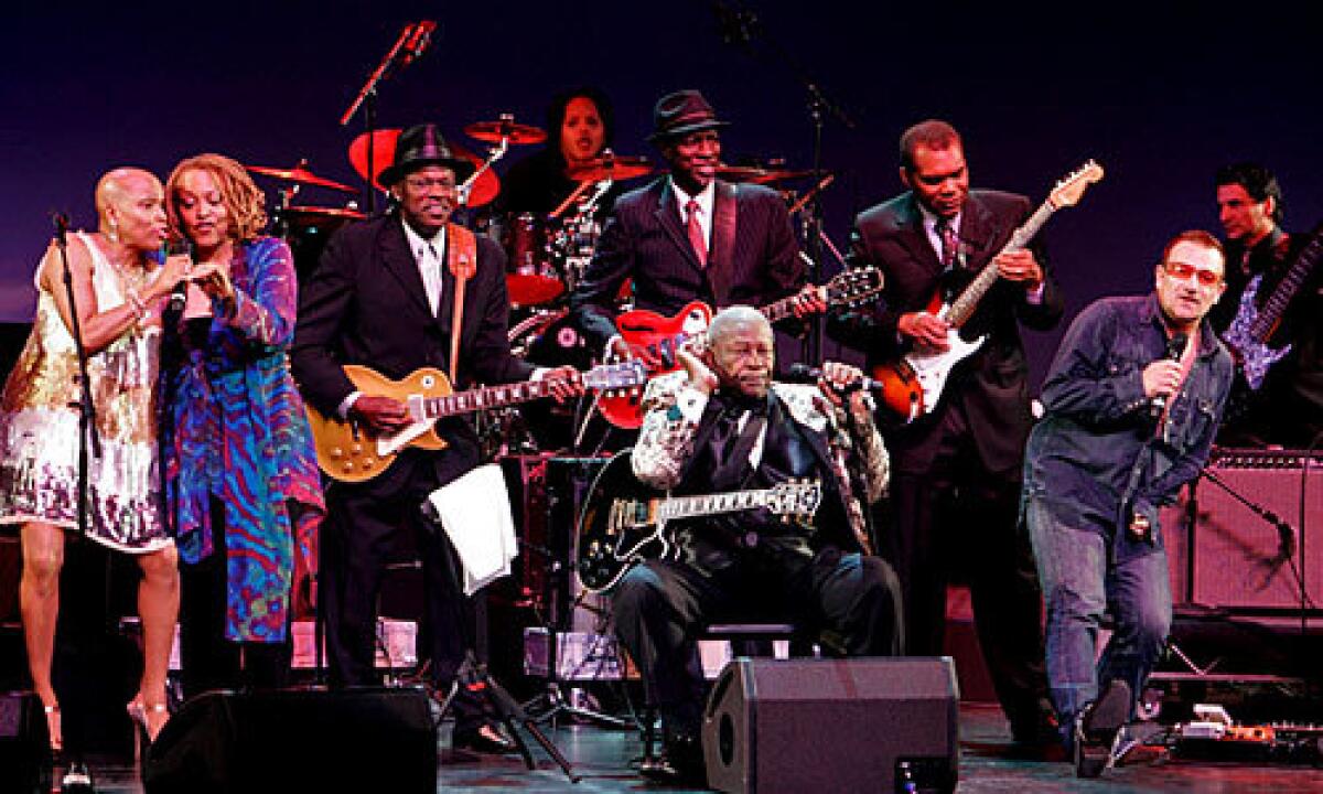 Bono genuflects before Monk Institute honoree B.B. King during a performance Sunday at the Kodak Theatre.