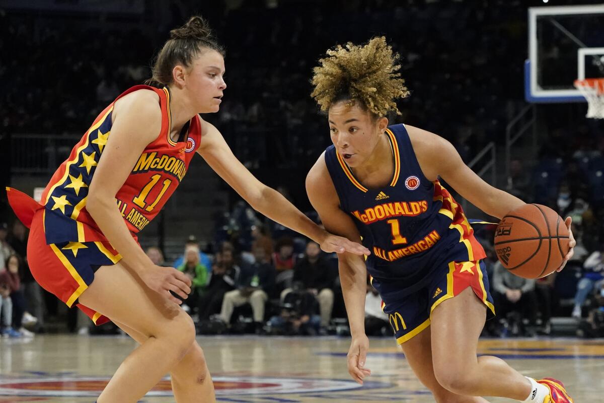 West star Gabriela Jaquez, left, defends the East's Kiki Rice.