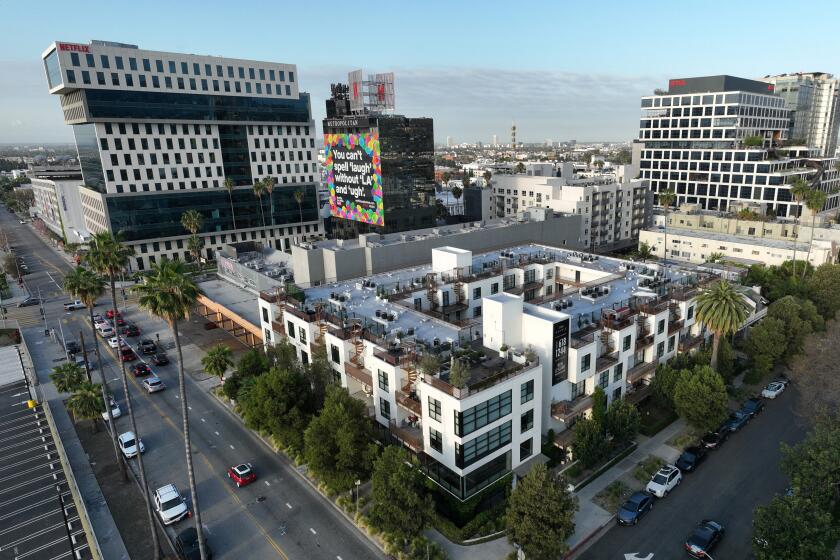 LOS ANGELES, CA - APRIL 24: (TWO-PICTURE PANORAMA) The apartment building at 5800 Harold Way in Los Angeles, CA (foreground) is under rent control. Most people assume rent control in Los Angeles applies to buildings built before 1978 but because of a relatively unknown city law, there are thousands of new buildings that also fall under rent control. Photographed on Harold Way in Los Angeles, CA on Wednesday, April 24, 2024. (Myung J. Chun / Los Angeles Times)