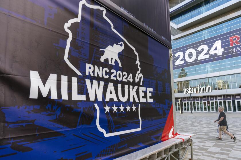 People walk past the Fiserv Forum ahead of the 2024 Republican National Convention, Thursday, July 11, 2024, in Milwaukee. (AP Photo/Alex Brandon)