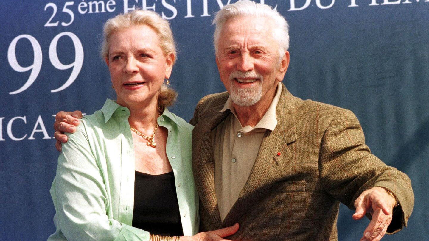 Old drama school buddies Bacall and Kirk Douglas pal around before a screening of their film "Diamonds" at the Deauville American Film Festival in France on Sept. 7, 1999.