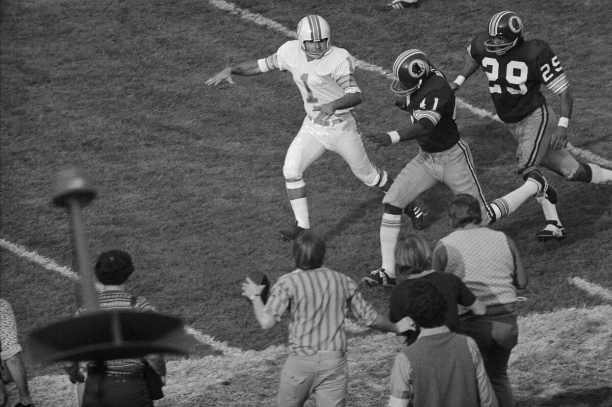 Washington's Mike Bass (41) runs for a score after kicker Garo Yepremian (1) threw a pass that was intercepted.