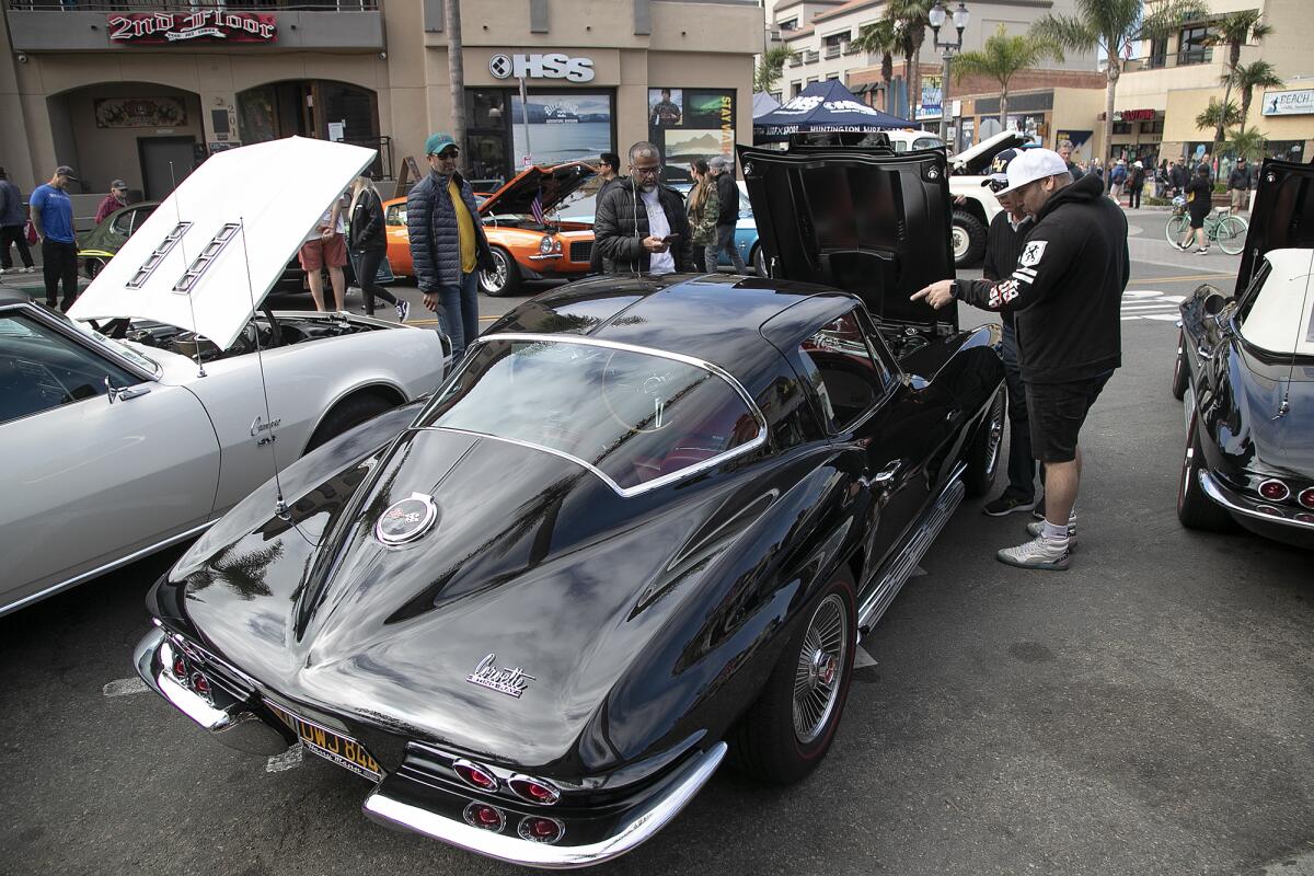 Classic car enthusiasts check out a 1967 Chevrolet Corvette Sting Ray.
