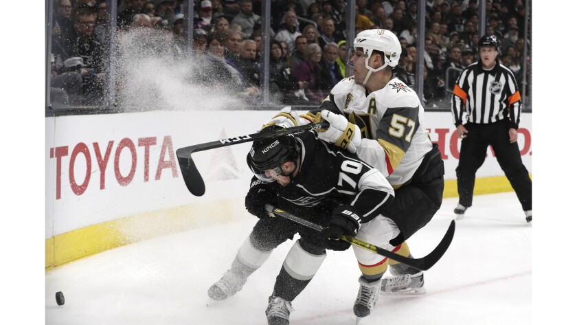 Kings forward Tanner Pearson races Golden Knights forward David Perron to the puck during first period action.