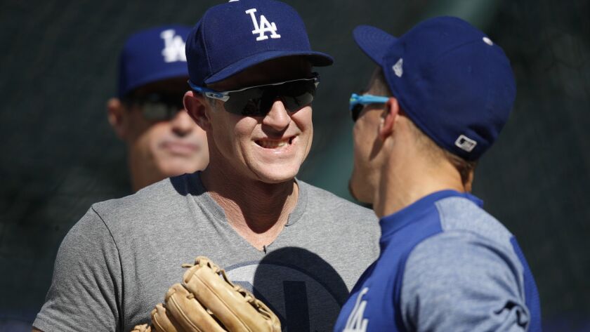 Chase Utley, left, jokes with Dodgers teammate Enrique Hernandez before a game in August.