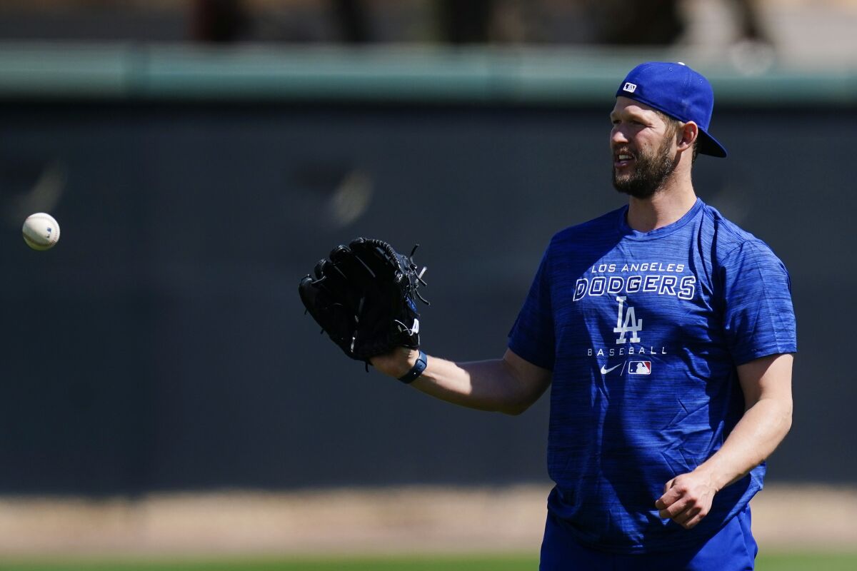 Dodgers pitcher Clayton Kershaw warms up during a spring training workout.