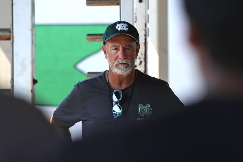 Tom Hatch, former Costa Mesa city manager, works with the freshman football team in the weight room during summer practice at Costa Mesa High School. Hatch left the city position in 2018 to take a job with the county, and has settled into what he describes as his dream job, an assistant football coach at Costa Mesa high school.