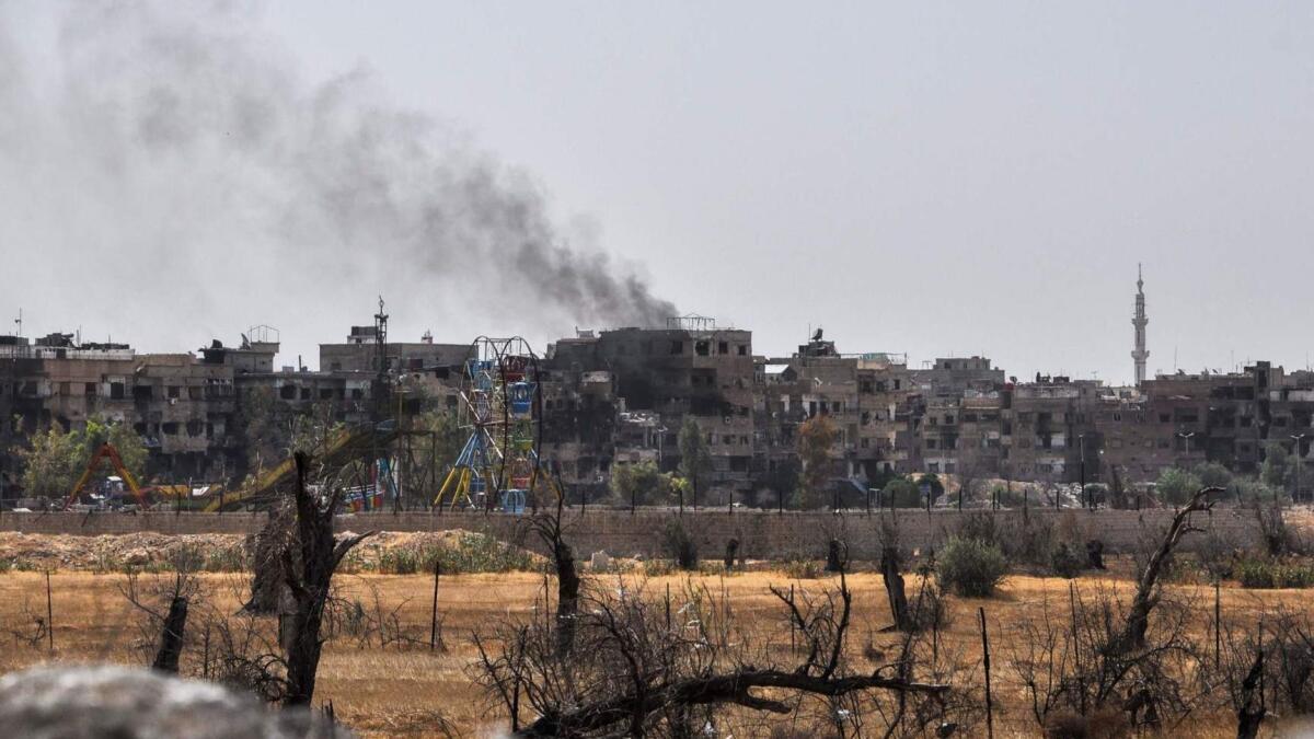 Smoke rises from the Syrian city of Duma on Friday. An investigative team from the Organization for the Prohibition of Chemical Weapons arrived in the city Saturday.