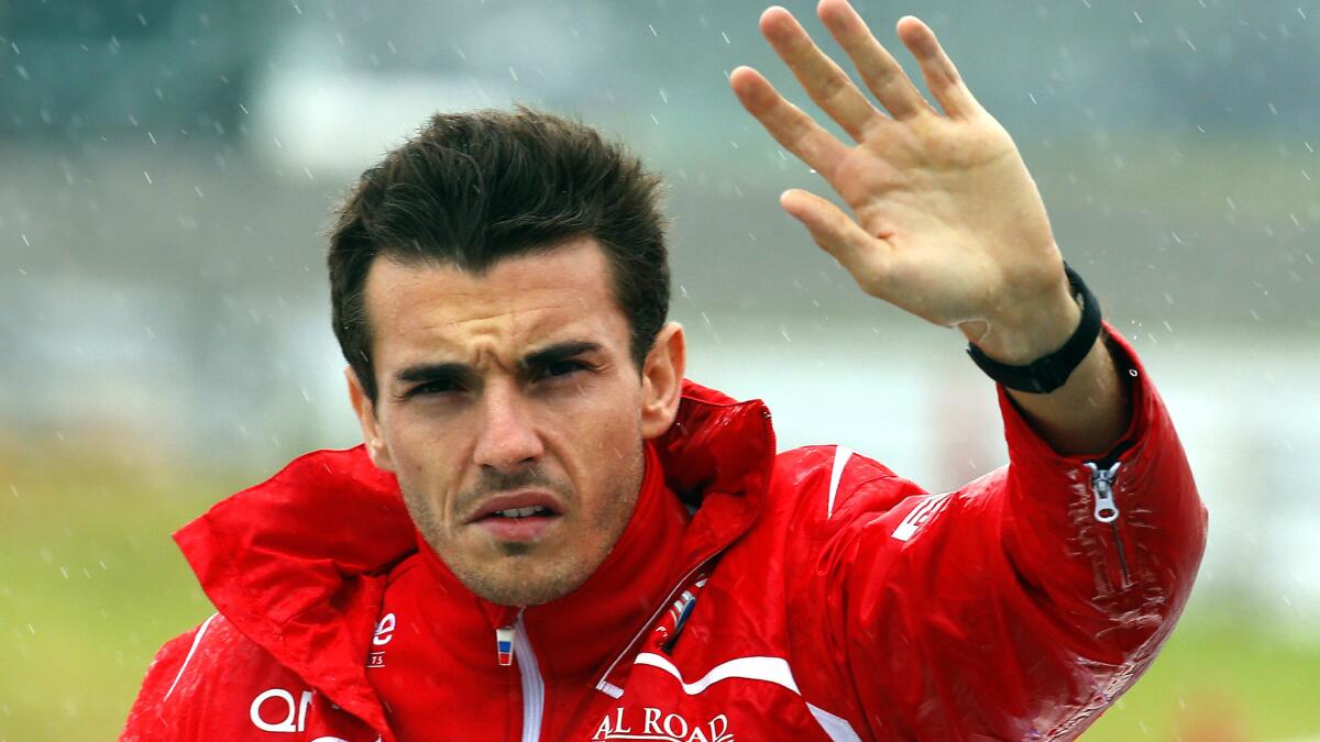 Formula One driver Jules Bianchi waves to fans during introductions before the Japanese Formula One Grand Prix at the Suzuka Circuit on Oct. 5, 2014.