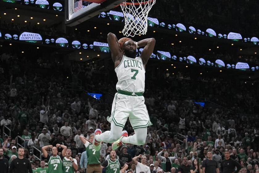 Boston Celtics guard Jaylen Brown goes up for a dunk against the Dallas Mavericks.