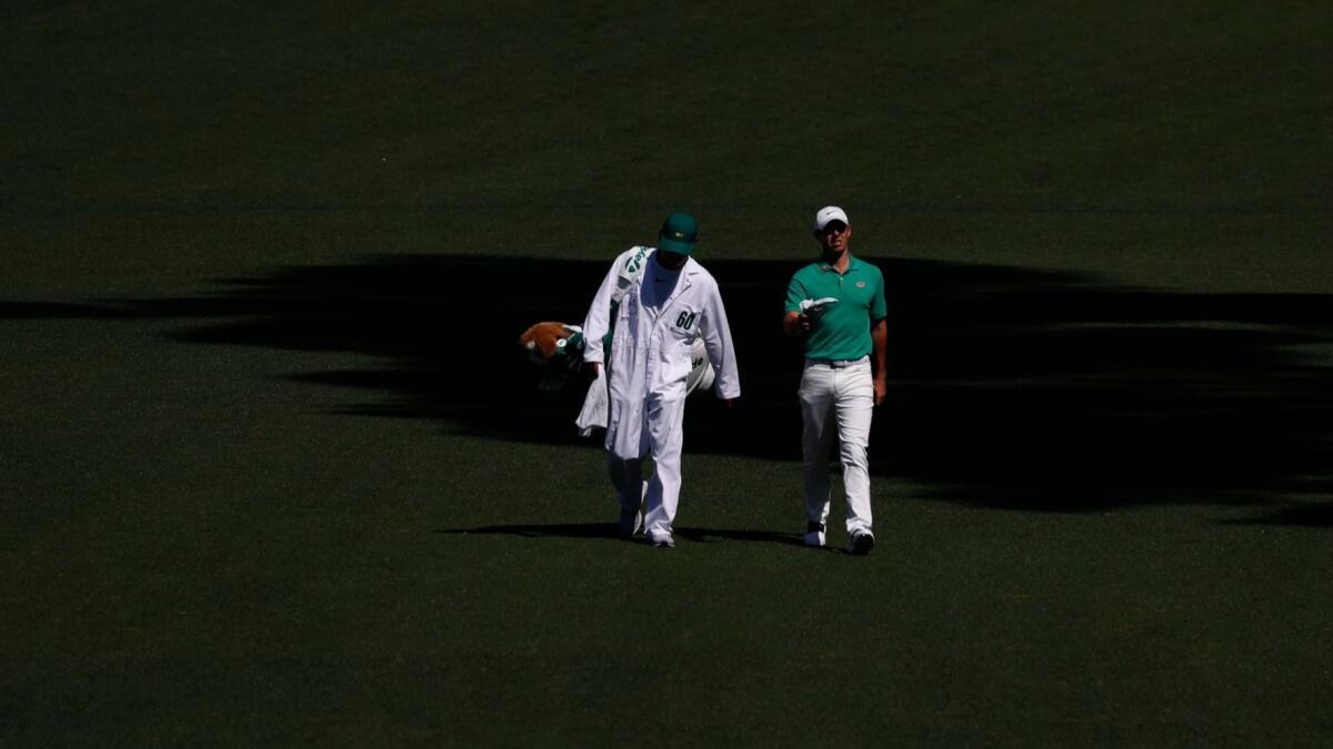 Rory McIlroy and his caddie walk up to the green on the second hole during a practice round for the Masters on Wednesday.
